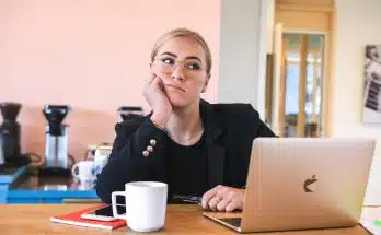 woman in black long sleeve shirt using macbook